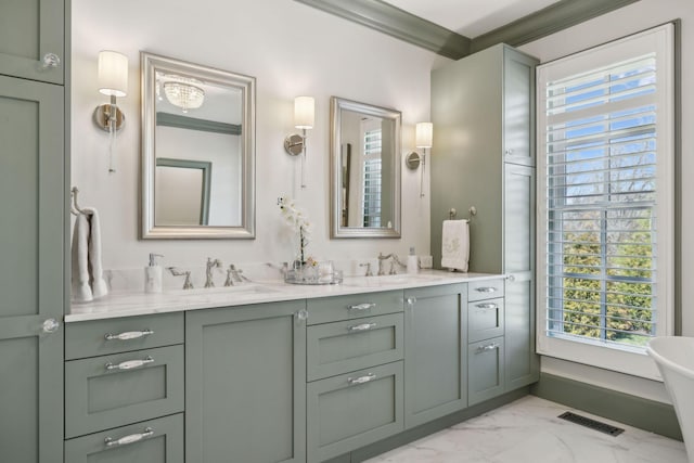 bathroom featuring visible vents, double vanity, ornamental molding, a sink, and marble finish floor