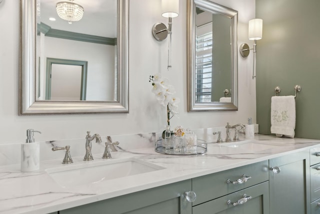 bathroom featuring double vanity, ornamental molding, and a sink