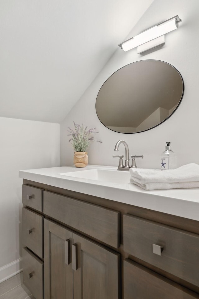 bathroom with vanity and vaulted ceiling