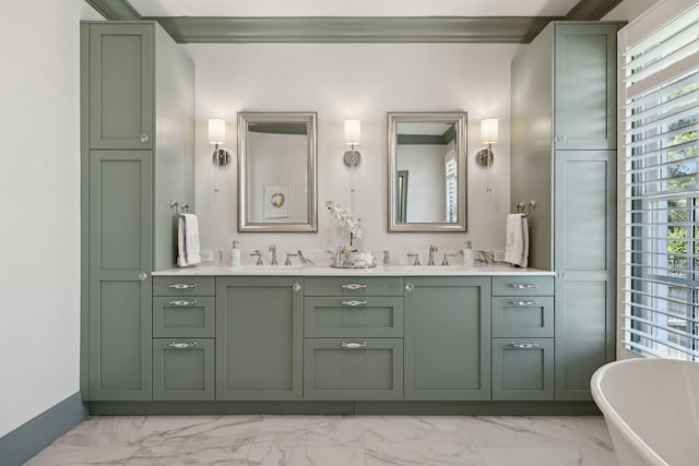 bathroom featuring double vanity, a soaking tub, marble finish floor, and a sink