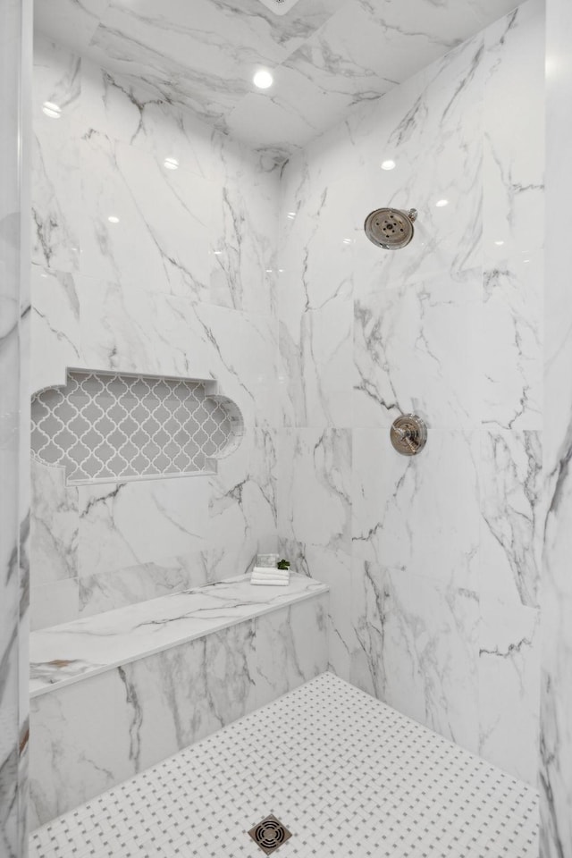 full bathroom with a marble finish shower