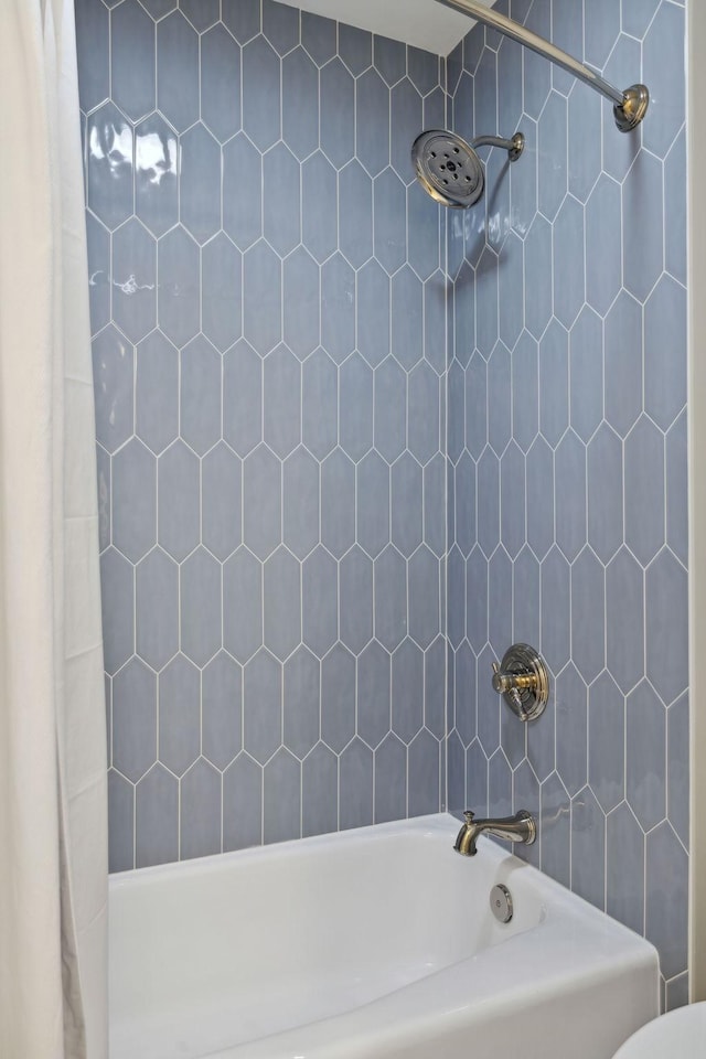 bathroom with shower / bathtub combination with curtain