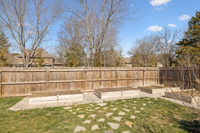 view of yard with a vegetable garden and fence