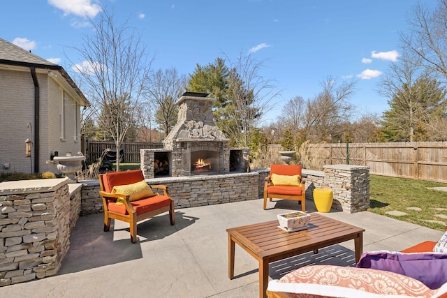 view of patio with fence and an outdoor stone fireplace