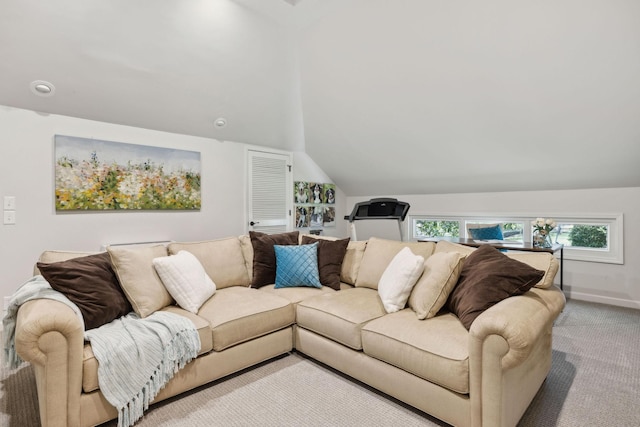 carpeted living area featuring baseboards and lofted ceiling