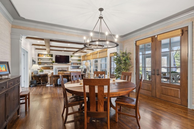 dining room featuring dark wood-type flooring, beamed ceiling, french doors, a fireplace, and a notable chandelier