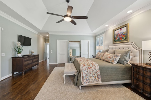 bedroom with crown molding, wood finished floors, baseboards, and lofted ceiling