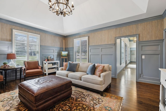 living room with vaulted ceiling, an inviting chandelier, a decorative wall, a raised ceiling, and dark wood-style flooring