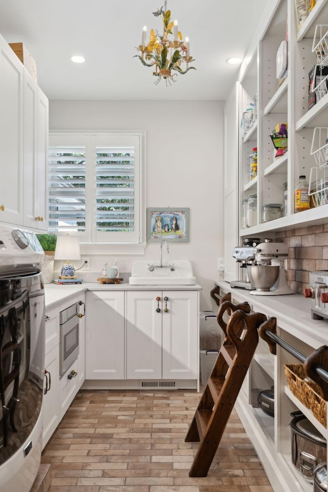 pantry with visible vents and a sink