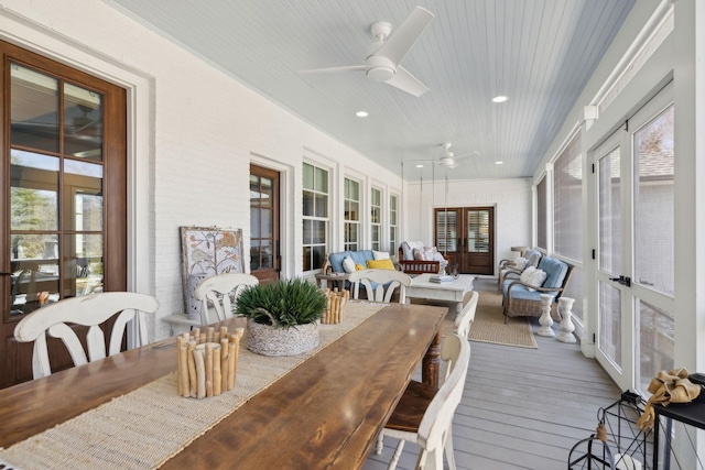 sunroom featuring french doors and a ceiling fan