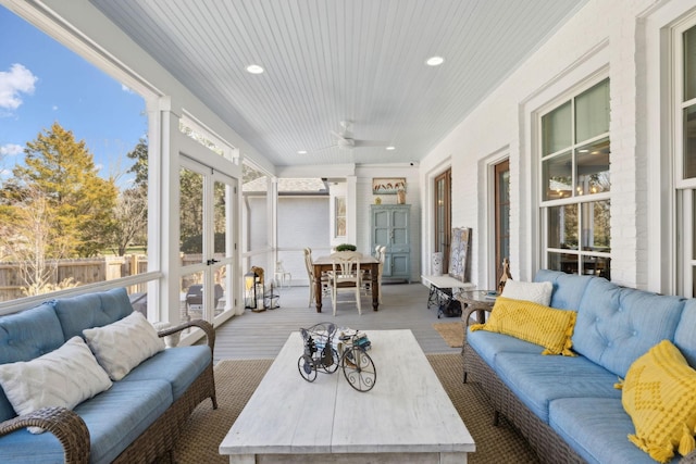 sunroom featuring french doors, wood ceiling, and a ceiling fan