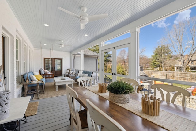 sunroom / solarium with plenty of natural light, french doors, wood ceiling, and a ceiling fan