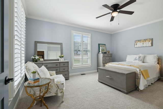 carpeted bedroom with visible vents, a ceiling fan, baseboards, and ornamental molding