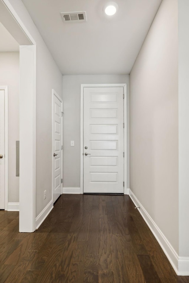 interior space featuring visible vents, baseboards, and dark wood-style flooring