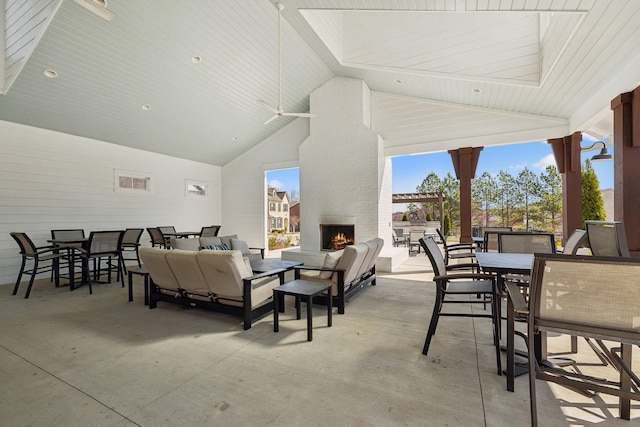 view of patio / terrace featuring an outdoor living space with a fireplace and outdoor dining area