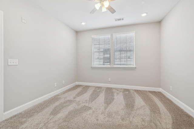 empty room with visible vents, recessed lighting, carpet, baseboards, and ceiling fan