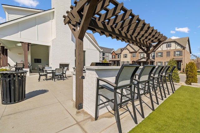 view of patio / terrace with outdoor dry bar, a residential view, and a pergola