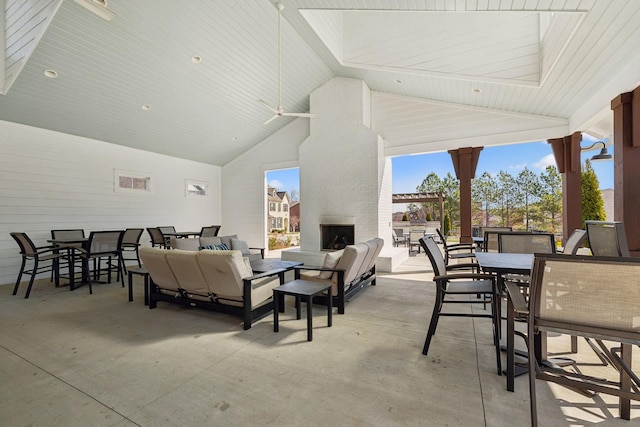 view of patio / terrace with outdoor dining area and an outdoor living space with a fireplace