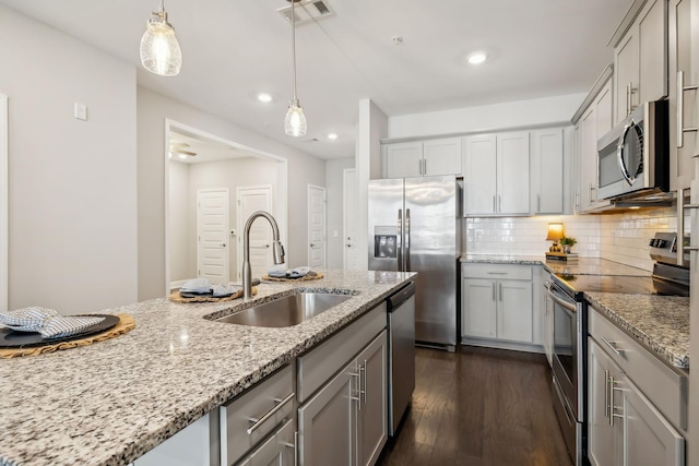 kitchen featuring visible vents, appliances with stainless steel finishes, gray cabinetry, and a sink