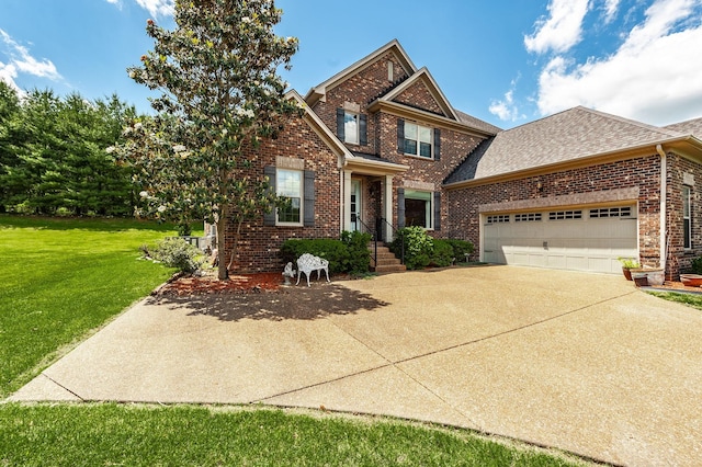 view of front of house featuring a front lawn, an attached garage, brick siding, and driveway