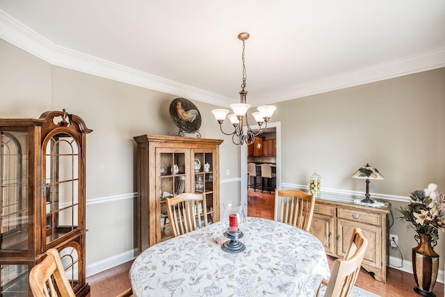 1013 Five Coves Trce, Gallatin, TN 37066 - dining space with crown molding, a notable chandelier, wood finished floors, and baseboards