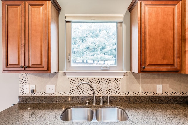 1013 Five Coves Trce, Gallatin, TN 37066 - kitchen with a sink, decorative backsplash, brown cabinetry, and dark stone countertops