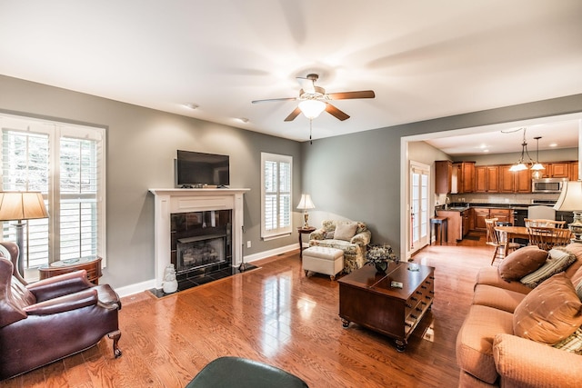 1013 Five Coves Trce, Gallatin, TN 37066 - living room with a healthy amount of sunlight, baseboards, light wood-style floors, and ceiling fan