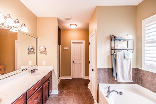 1013 Five Coves Trce, Gallatin, TN 37066 - bathroom featuring tile patterned floors, visible vents, a sink, double vanity, and a bath