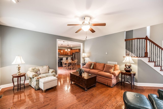 1013 Five Coves Trce, Gallatin, TN 37066 - living area featuring baseboards, light wood-style floors, stairs, and ceiling fan with notable chandelier