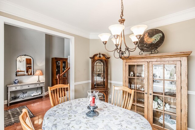 1013 Five Coves Trce, Gallatin, TN 37066 - dining room featuring a chandelier, crown molding, and wood finished floors