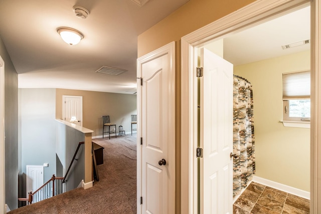 1013 Five Coves Trce, Gallatin, TN 37066 - corridor featuring an upstairs landing, visible vents, dark colored carpet, and baseboards