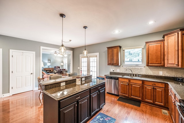 1013 Five Coves Trce, Gallatin, TN 37066 - kitchen featuring visible vents, light wood-style flooring, a sink, stainless steel dishwasher, and decorative backsplash