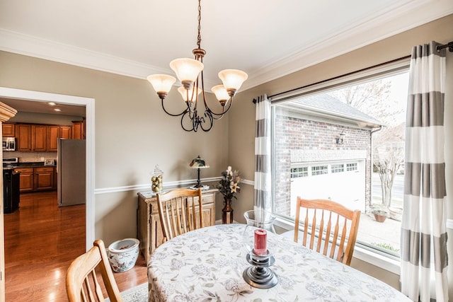 1013 Five Coves Trce, Gallatin, TN 37066 - dining room with a chandelier, dark wood finished floors, and ornamental molding
