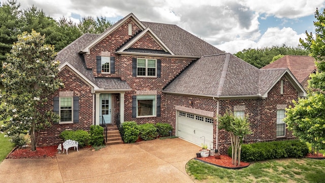 1013 Five Coves Trce, Gallatin, TN 37066 - craftsman inspired home featuring a garage, brick siding, roof with shingles, and driveway