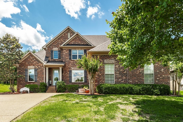1013 Five Coves Trce, Gallatin, TN 37066 - view of front of property featuring a front lawn, brick siding, and a shingled roof
