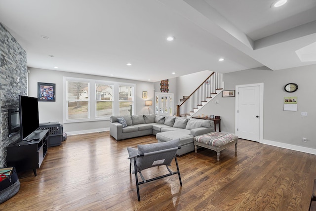 living room featuring stairs, recessed lighting, wood finished floors, and baseboards
