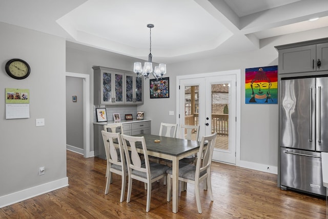 dining space featuring french doors, baseboards, an inviting chandelier, and dark wood-style flooring