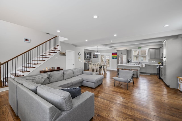 living room featuring a chandelier, stairway, recessed lighting, and dark wood-style flooring