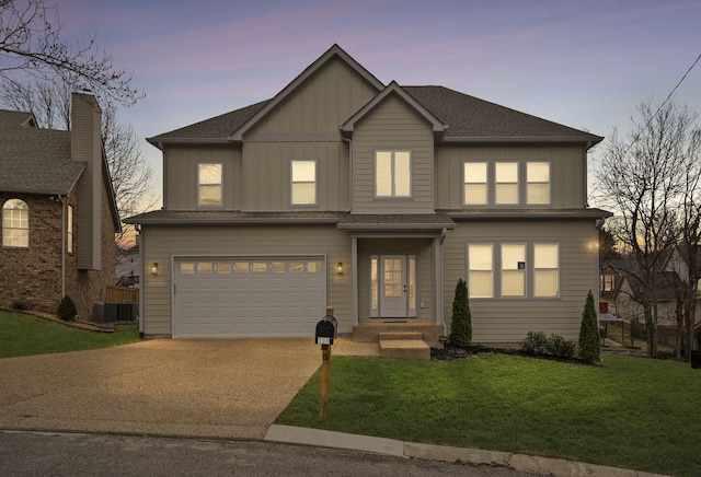 view of front of home with a garage, a front lawn, board and batten siding, and driveway
