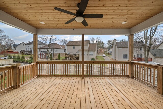 wooden terrace featuring a residential view and ceiling fan