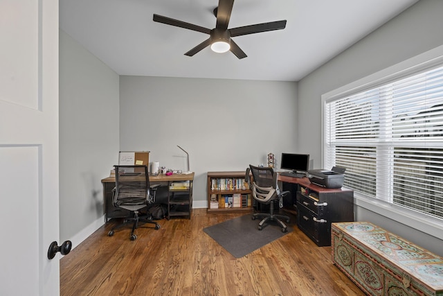 home office with baseboards, a ceiling fan, and wood finished floors