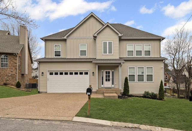 view of front of home with board and batten siding, concrete driveway, a front yard, central AC unit, and a garage