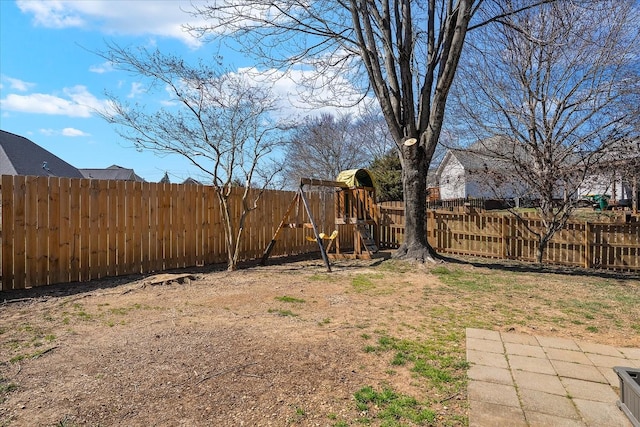 view of yard with a playground and a fenced backyard