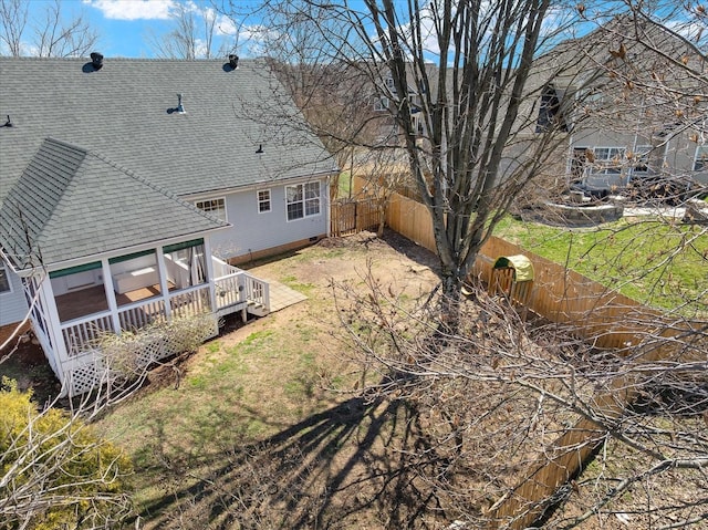 back of house featuring a deck, fence, and a shingled roof