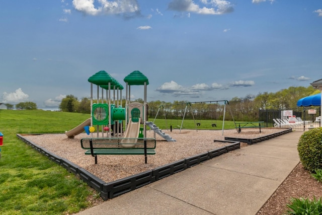 community playground featuring a lawn