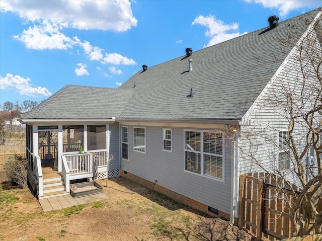 back of property with roof with shingles, a sunroom, and crawl space