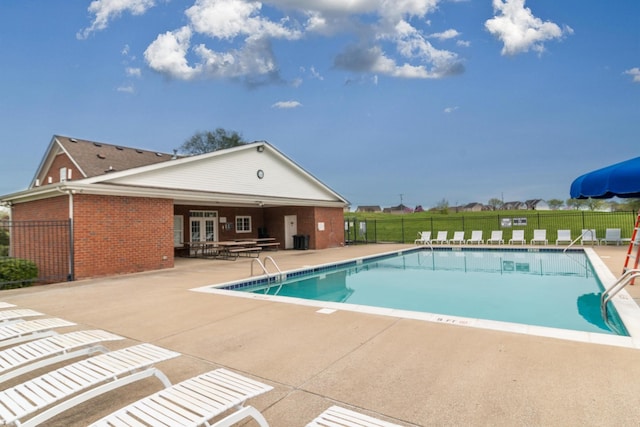 pool featuring a patio area, fence, and french doors