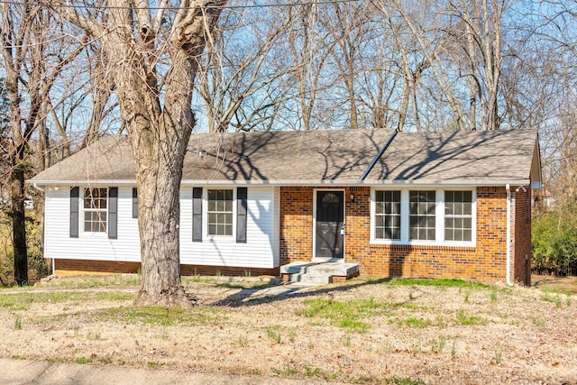 single story home featuring roof with shingles