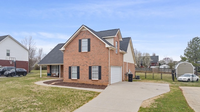 traditional-style home featuring fence, roof with shingles, concrete driveway, a front yard, and brick siding