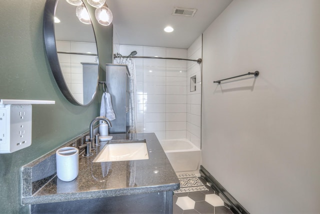 full bathroom with vanity, baseboards, visible vents, and shower / bathtub combination